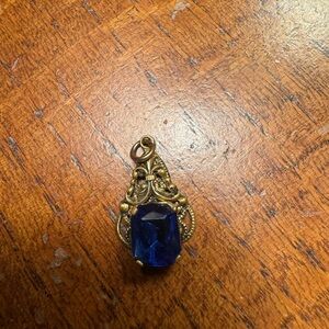 Pendant. My grandmothers 50 plus years old. Don’t know if the stone is authentic